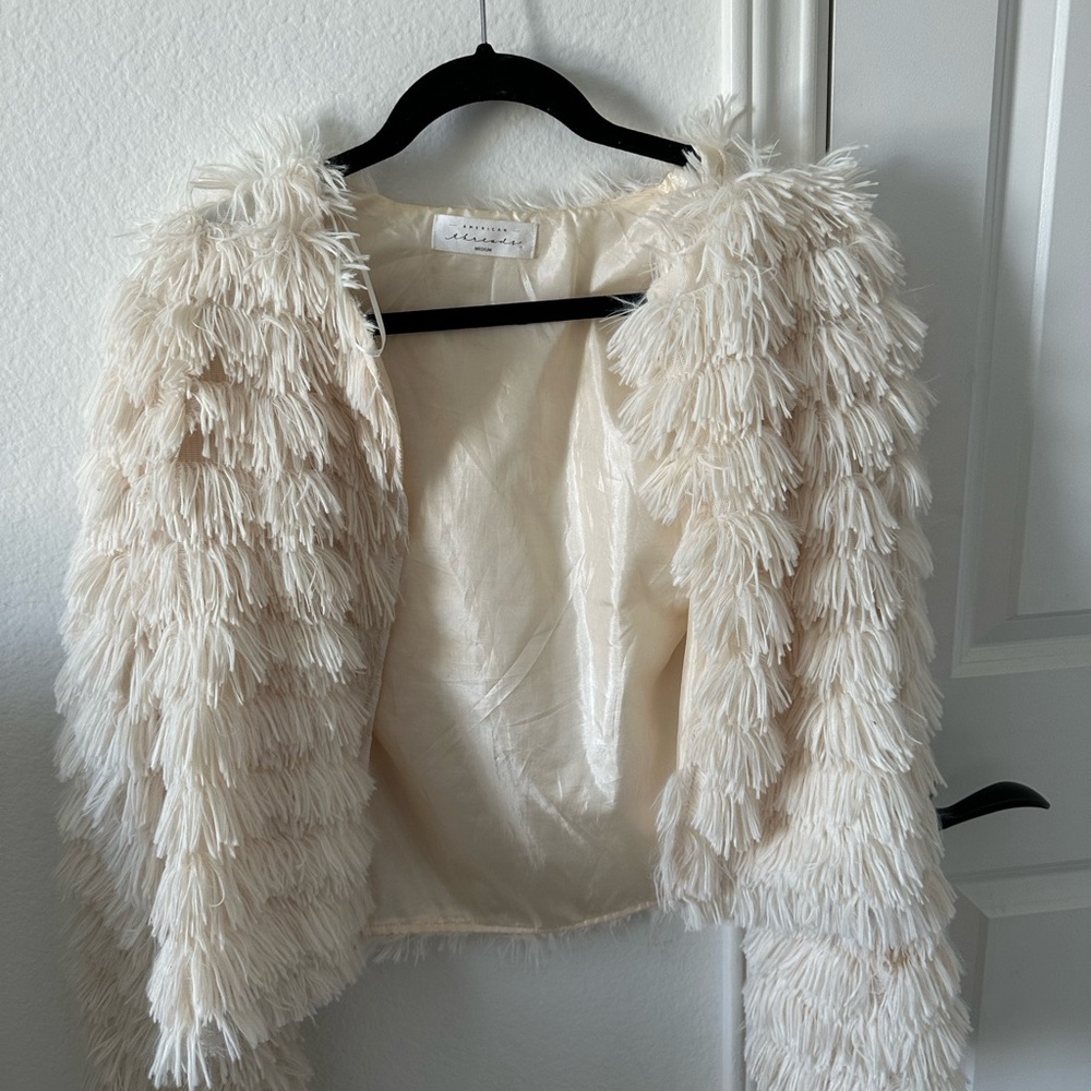 Fluffy slightly cropped white jacket.